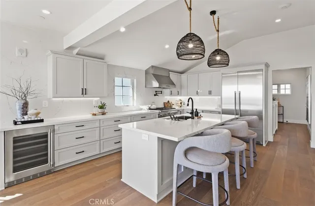 a kitchen with stainless steel appliances a table chairs and a chandelier