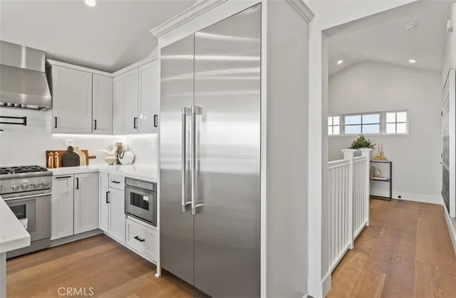 a kitchen with white cabinets and white appliances