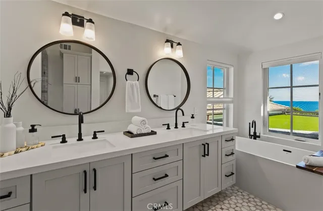 a bathroom with a double vanity sink and a mirror