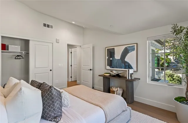 a bedroom with bed and a large window