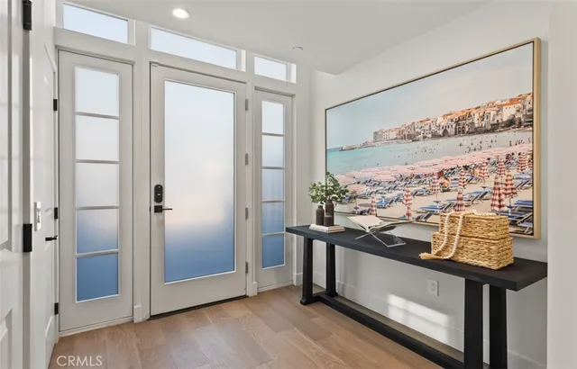 a view of hallway with stairs and wooden floor