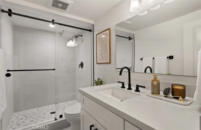 a bathroom with a sink toilet tub and shower