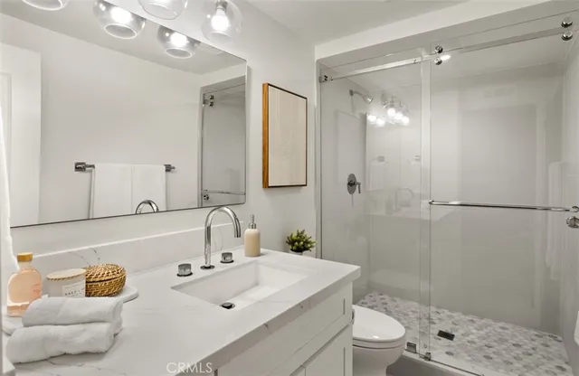 a living room with furniture a rug and wall paintings