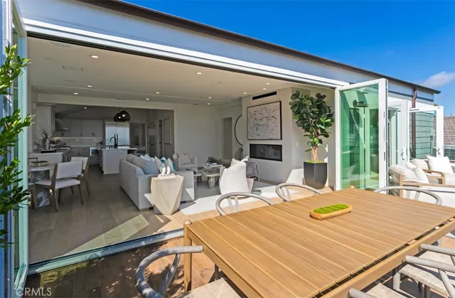 a view of a dining room with furniture large windows and wooden floor