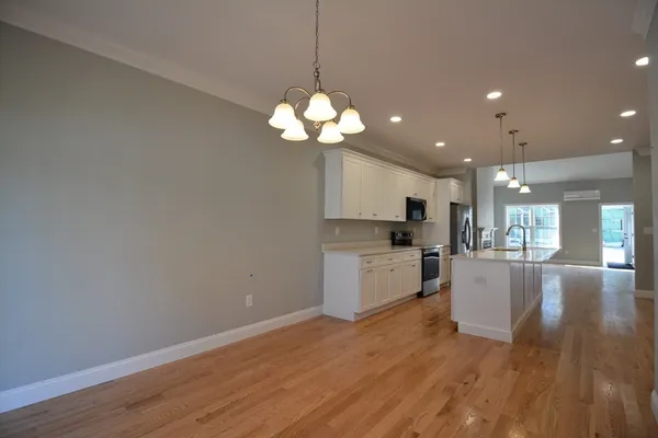 a open kitchen with a white cabinet and a stove top oven