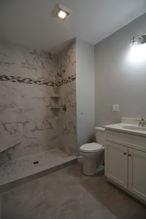 a bathroom with a sink toilet and shower