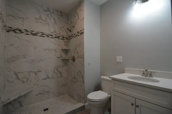 a bathroom with a shower toilet and sink