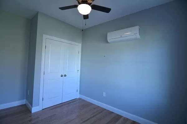 a view of an empty room with wooden floor