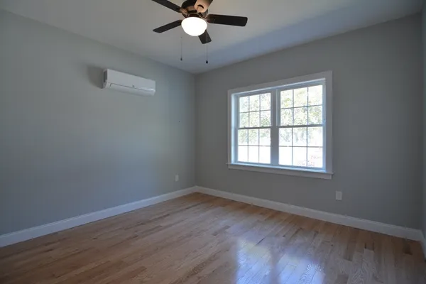a view of wooden floor and windows in a room
