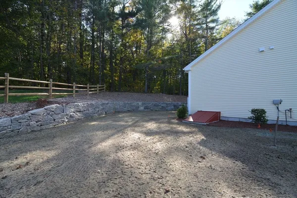 a view of a dirt road and trees