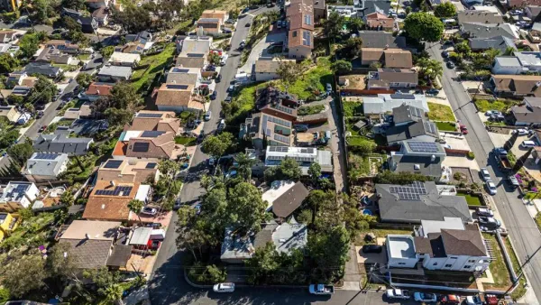 an aerial view of residential houses with outdoor space