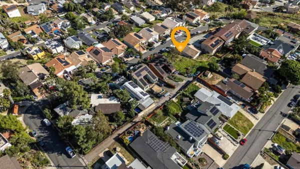 an aerial view of a house with a yard and outdoor seating