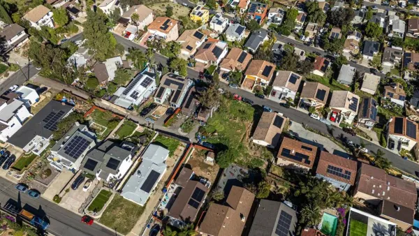 an aerial view of multi story residential apartment building with outdoor space and parking