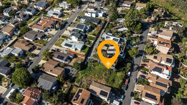 an aerial view of house with yard and swimming pool
