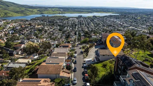an aerial view of a house with a swimming pool outdoor seating and yard