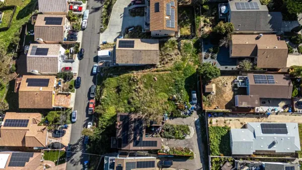 an aerial view of residential houses with outdoor space