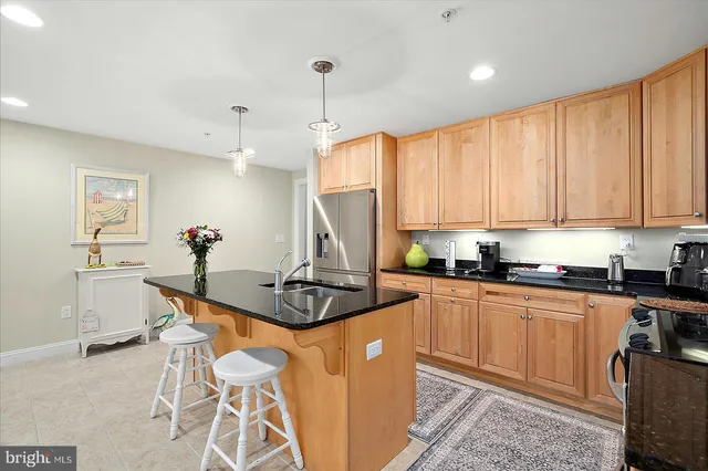 a kitchen with granite countertop white cabinets and stainless steel appliances