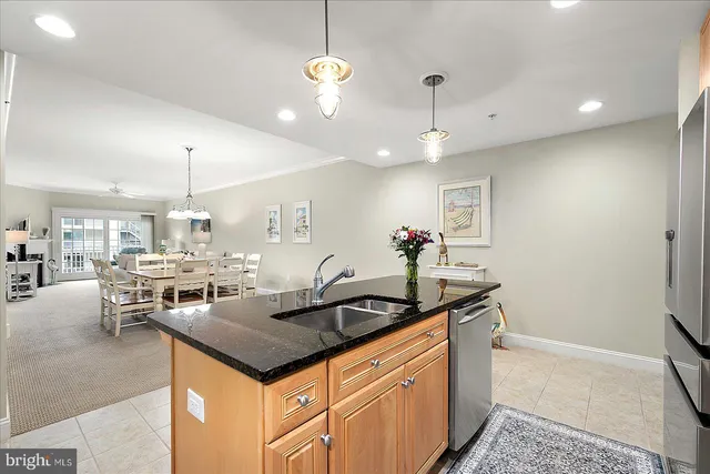 a dining room with a table chairs and kitchen view