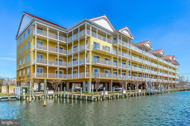 a front view of a building with lake view and a large building