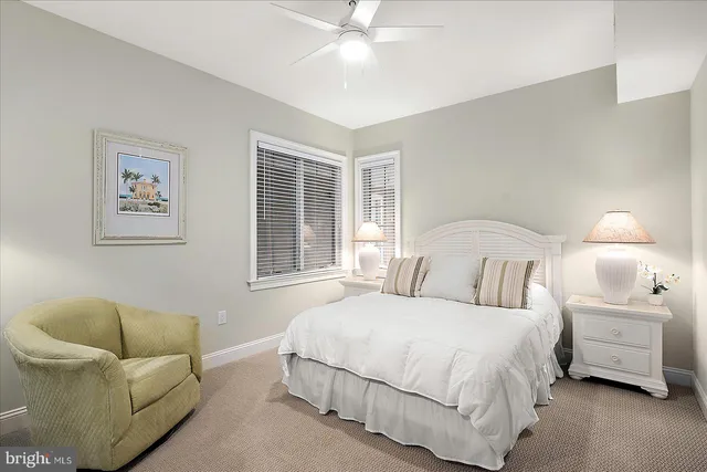 a bedroom with two beds and a window