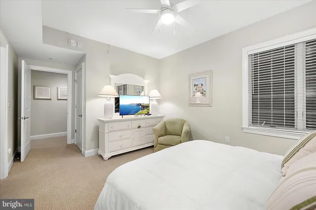 a bedroom with two beds and a chandelier