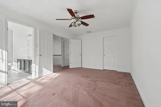 a view of a livingroom with a ceiling fan & a ceiling fan