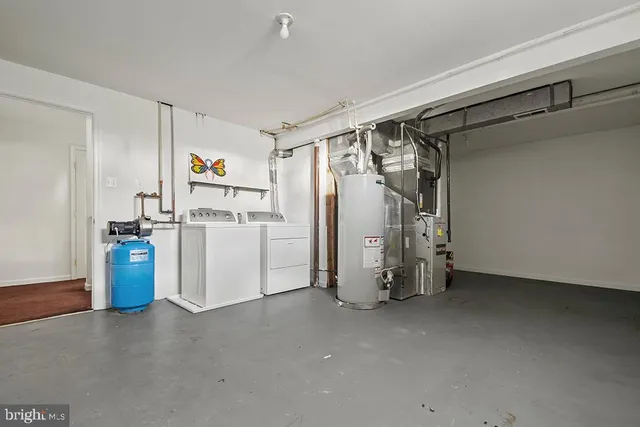 a view of storage and utility room with closet