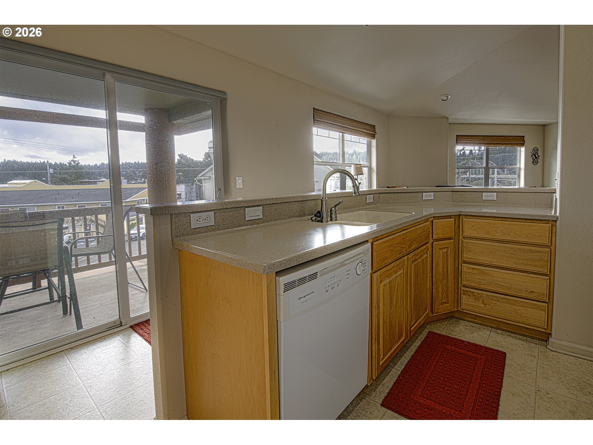 179 Laurel Street, Unit 9 Florence, OR 97439 - Photo 17 of 37 a kitchen with a sink stove and cabinets