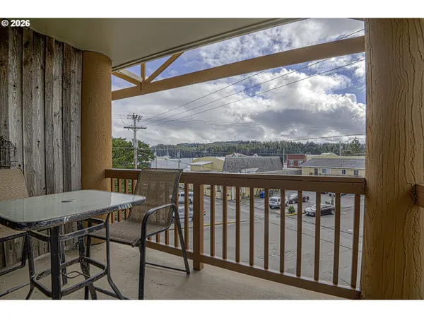 a view of a chairs and table in the balcony