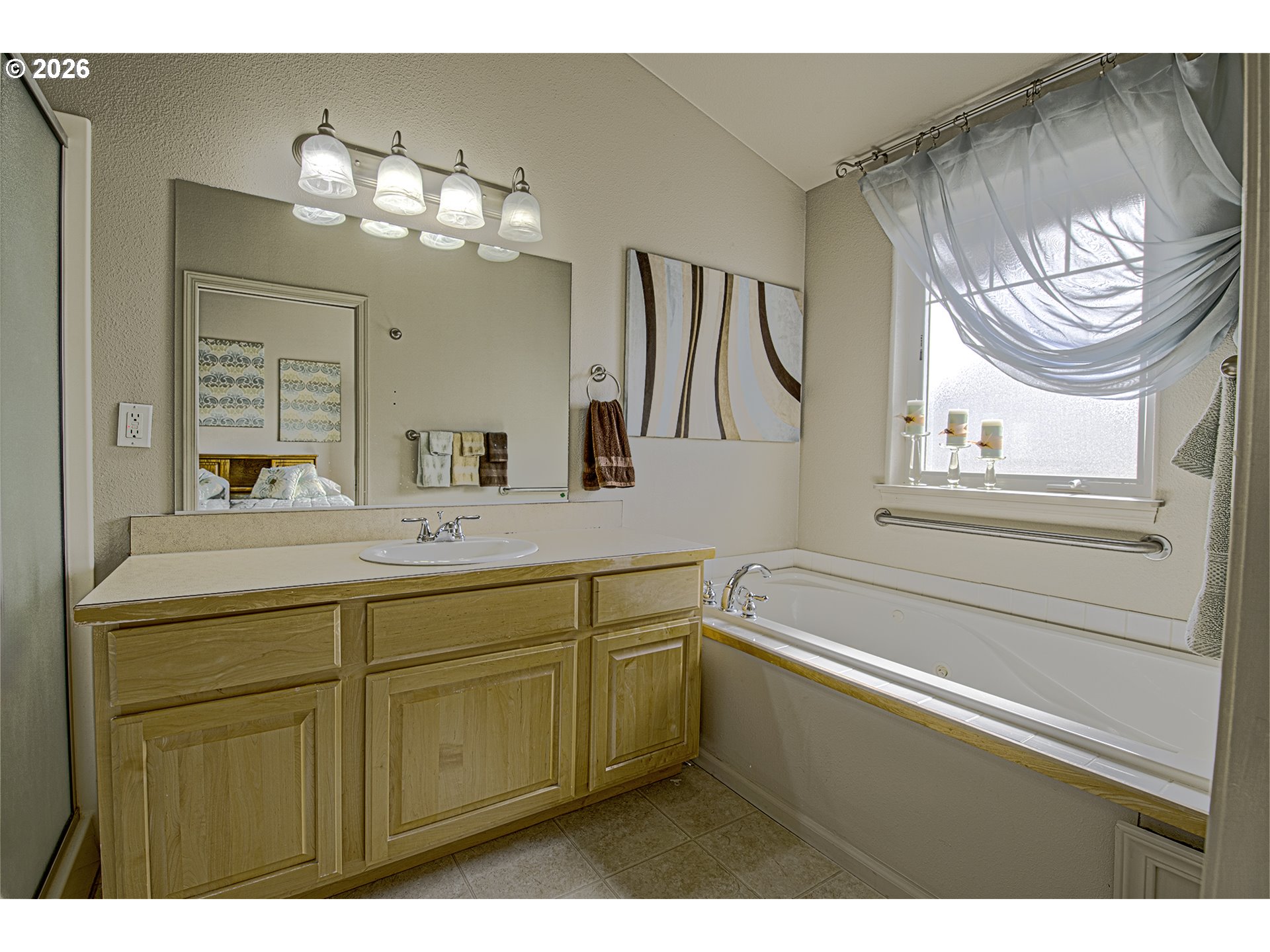 179 Laurel Street, Unit 9 Florence, OR 97439 - Photo 26 of 37 a bathroom with a sink a large mirror and a window