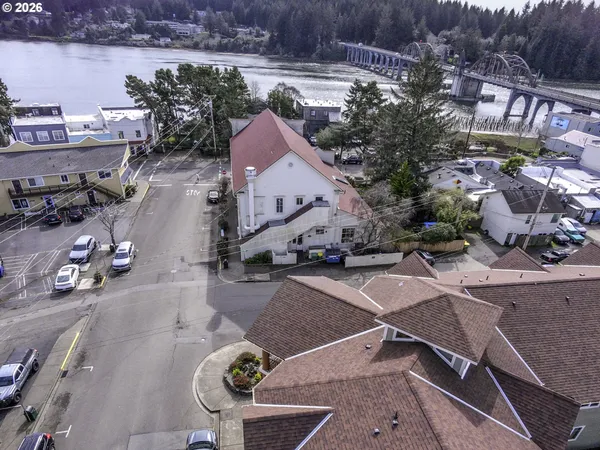 an aerial view of a house with garden space and street view