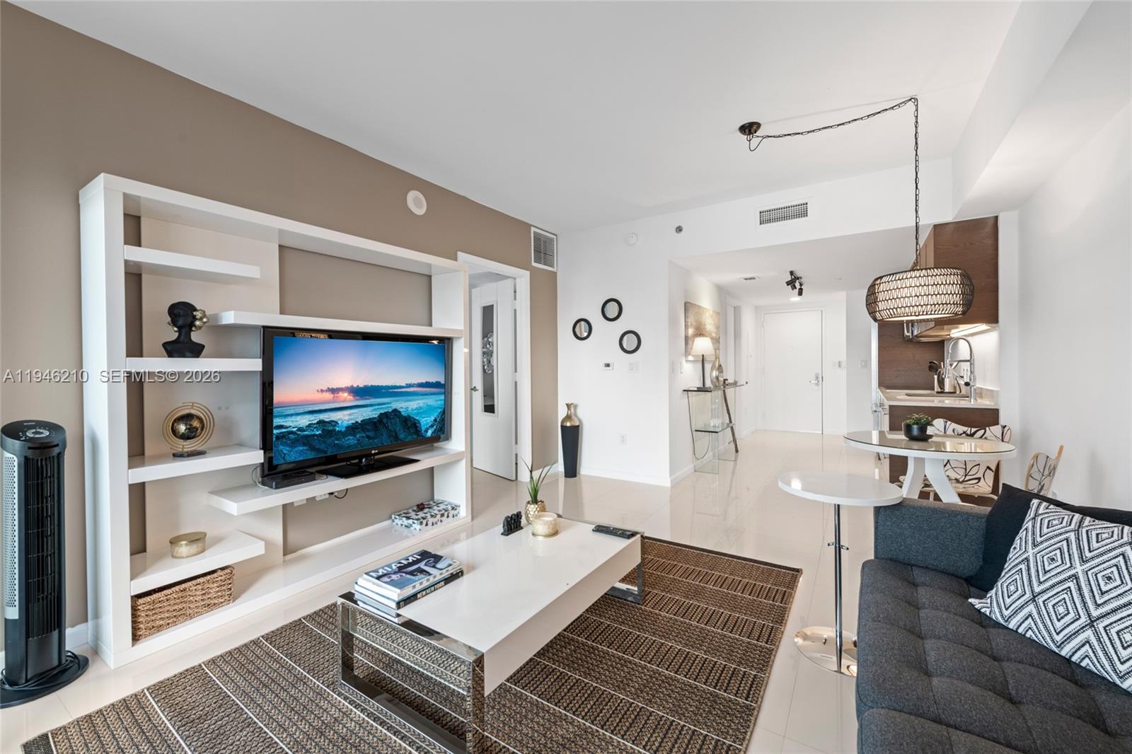 465 Brickell Avenue, Unit 904 Miami, FL 33131 - Photo 11 of 21 a living room with furniture and a flat screen tv