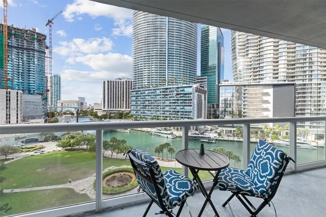 a balcony with table and chairs