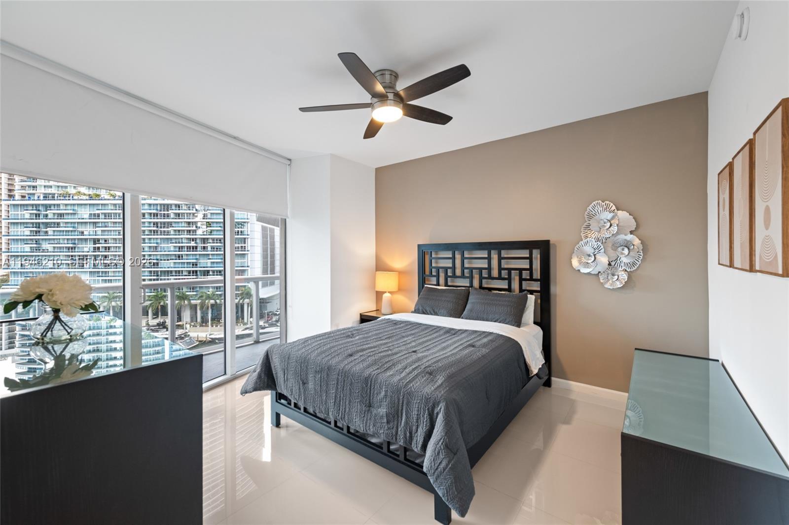 465 Brickell Avenue, Unit 904 Miami, FL 33131 - Photo 13 of 21 a bedroom with a large bed and a large window