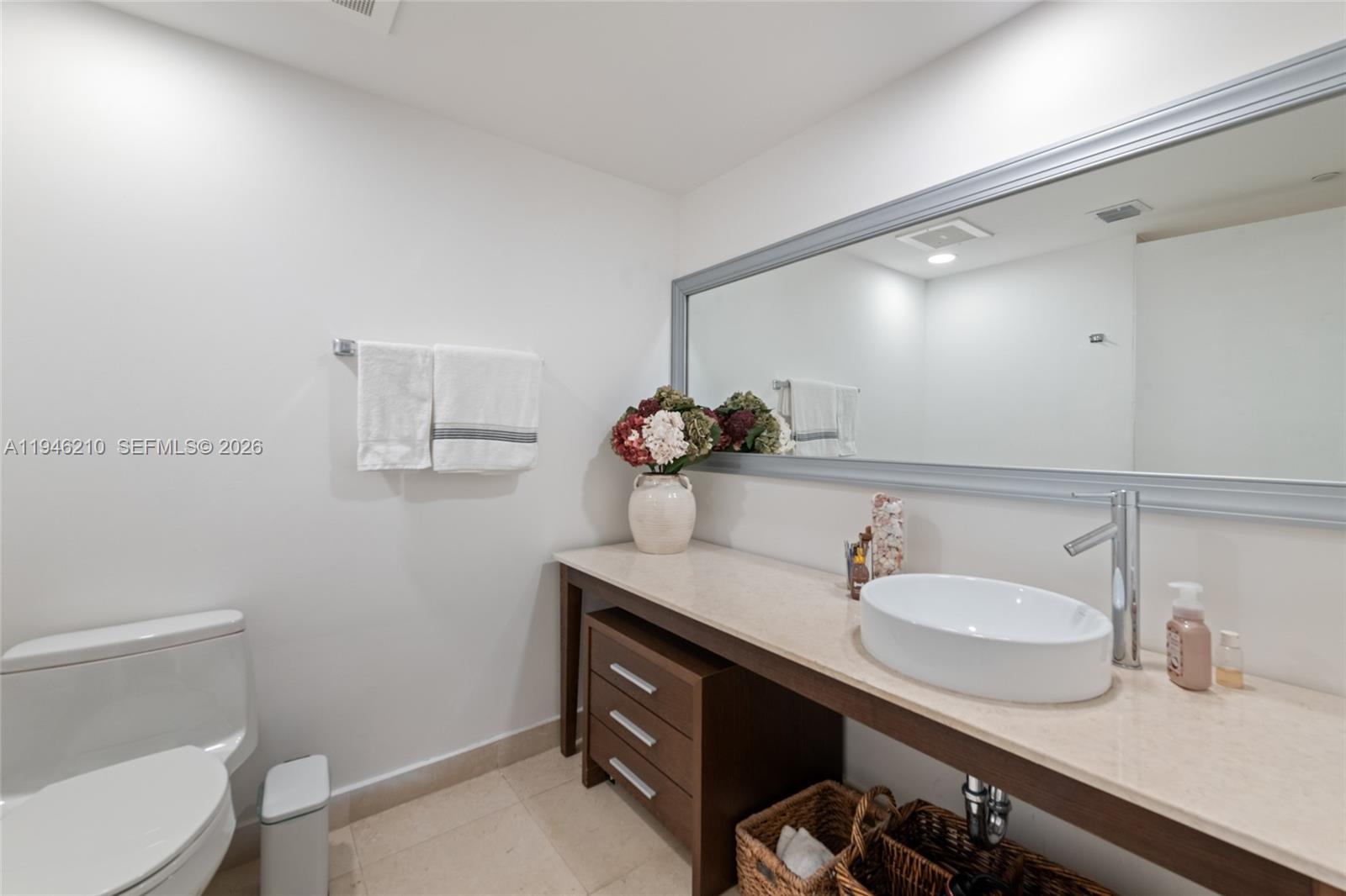 465 Brickell Avenue, Unit 904 Miami, FL 33131 - Photo 15 of 21 a bathroom with a sink vanity granite and toilet