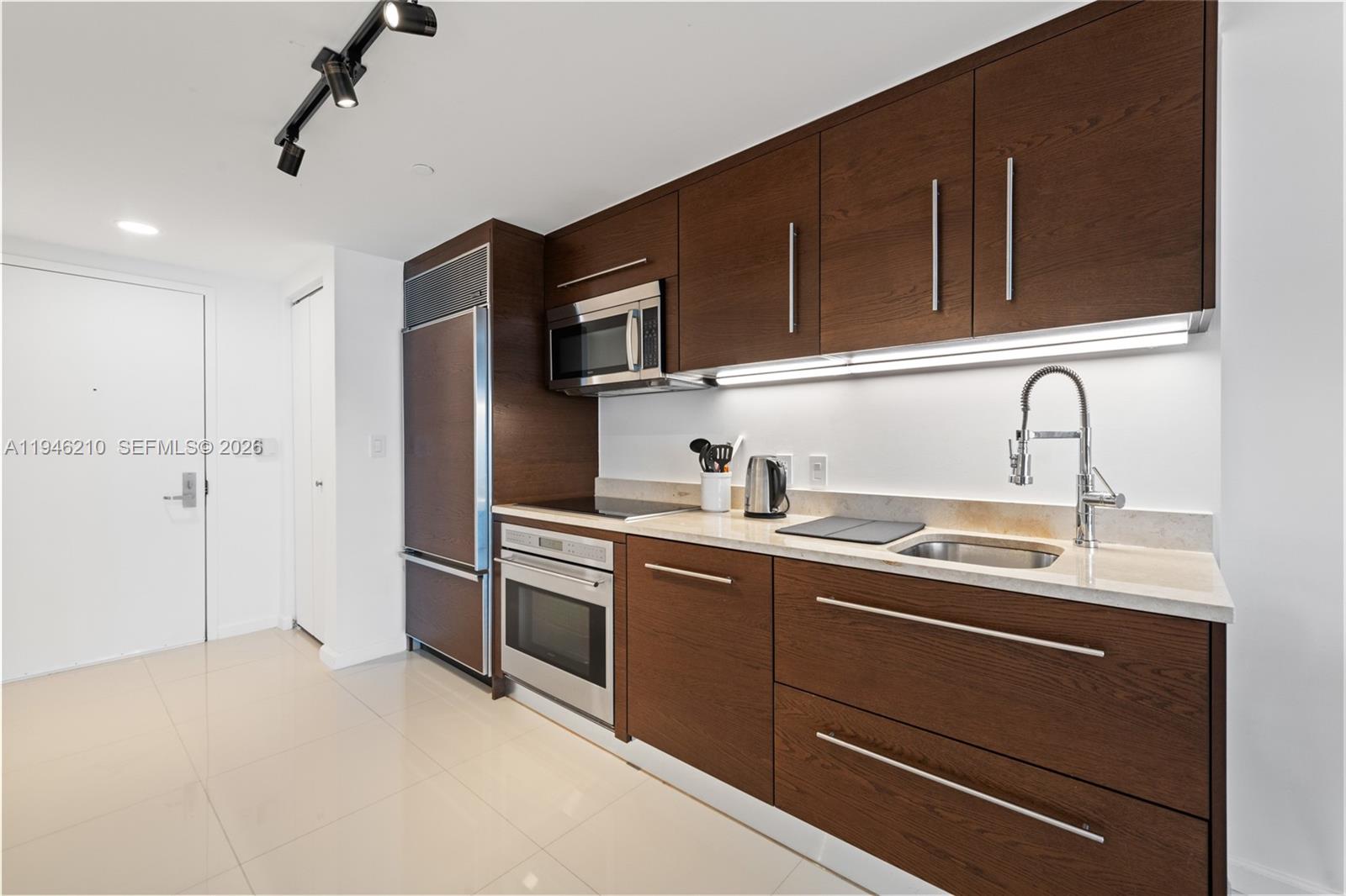 465 Brickell Avenue, Unit 904 Miami, FL 33131 - Photo 6 of 21 a kitchen with stainless steel appliances granite countertop a sink and a stove