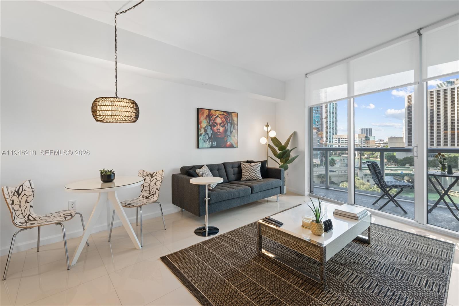 465 Brickell Avenue, Unit 904 Miami, FL 33131 - Photo 8 of 21 a living room with furniture a lamp and a table