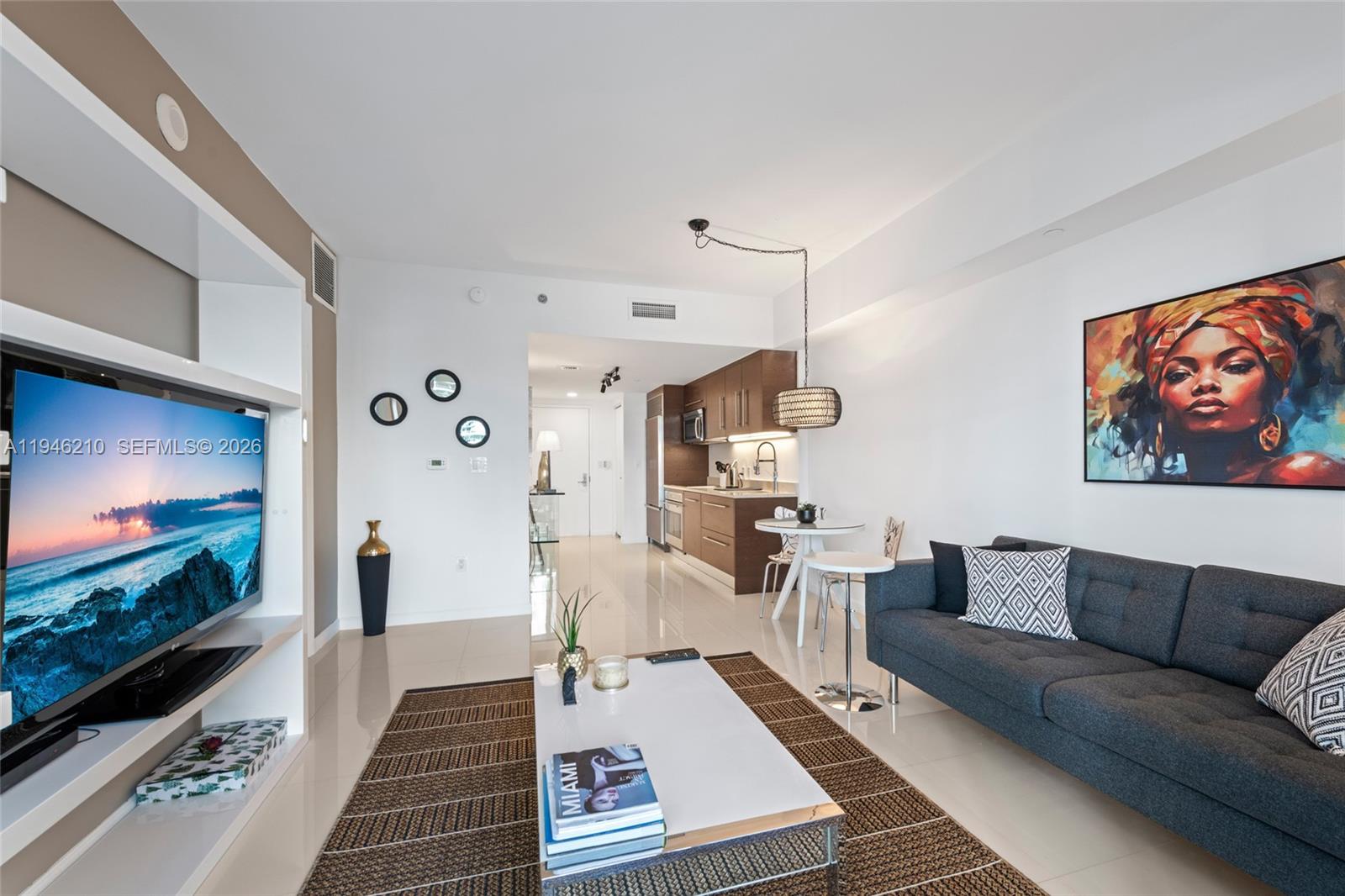 465 Brickell Avenue, Unit 904 Miami, FL 33131 - Photo 10 of 21 a living room with furniture and a flat screen tv