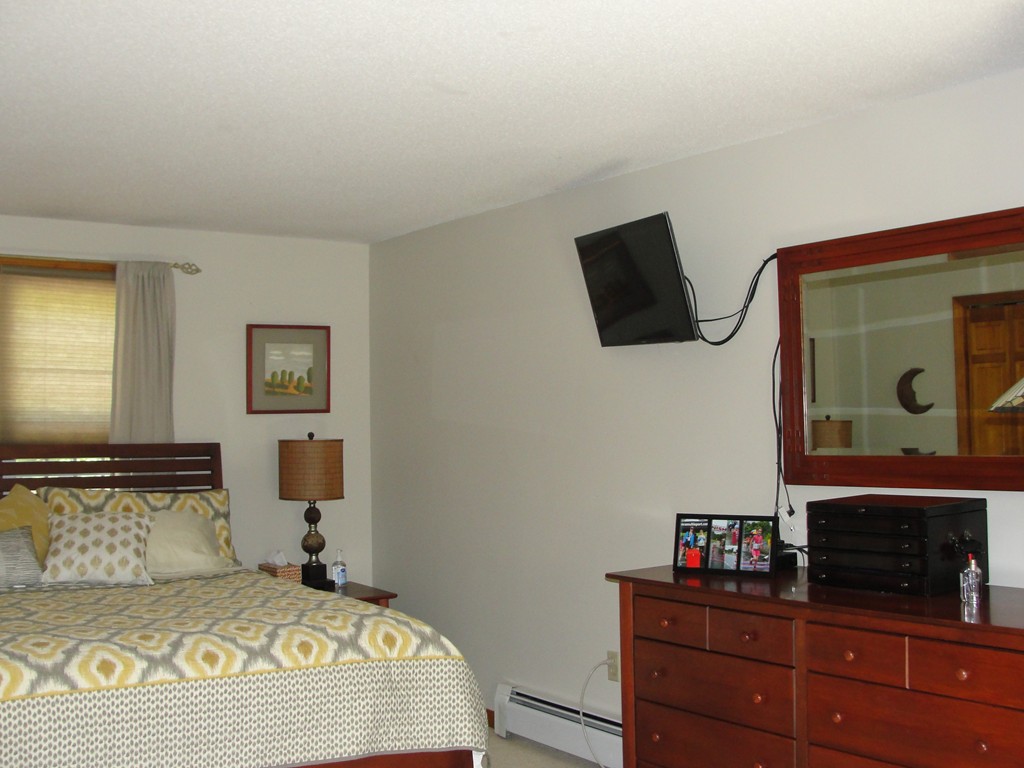133 Walnut Plain Road Rochester, MA 02770 - Photo 19 of 30 a bedroom with a bed and a television