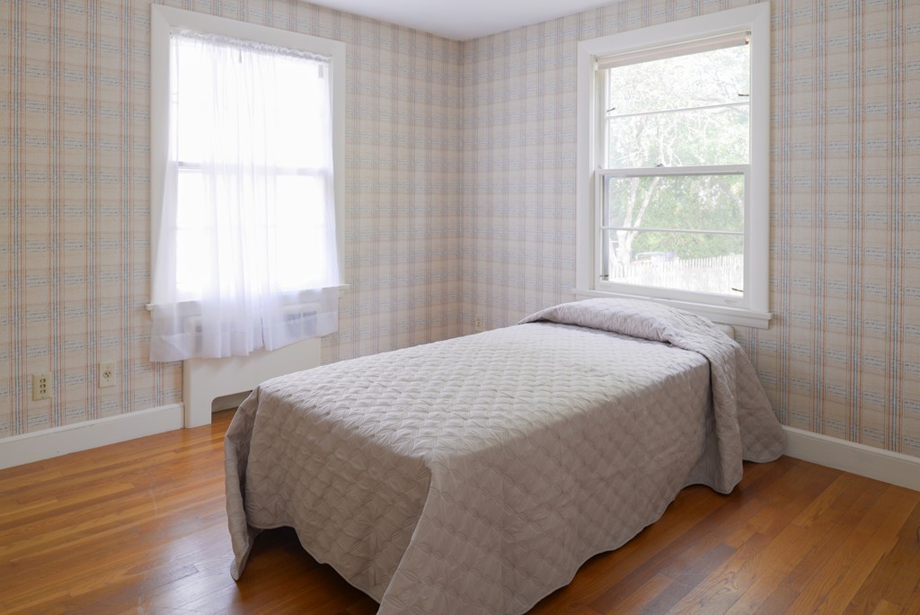 83 Lafayette Street Marblehead, MA 01945 - Photo 14 of 25 a bed sitting in a bedroom next to a window