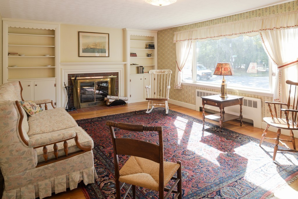 83 Lafayette Street Marblehead, MA 01945 - Photo 3 of 25 a living room with furniture a large window and a fireplace