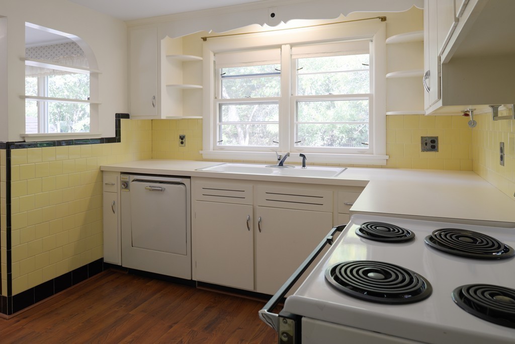 83 Lafayette Street Marblehead, MA 01945 - Photo 7 of 25 a kitchen with a sink stove and cabinets