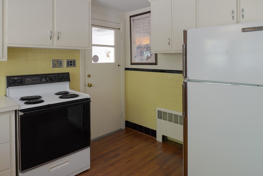 83 Lafayette Street Marblehead, MA 01945 - Photo 8 of 25 a kitchen with a refrigerator and a stove