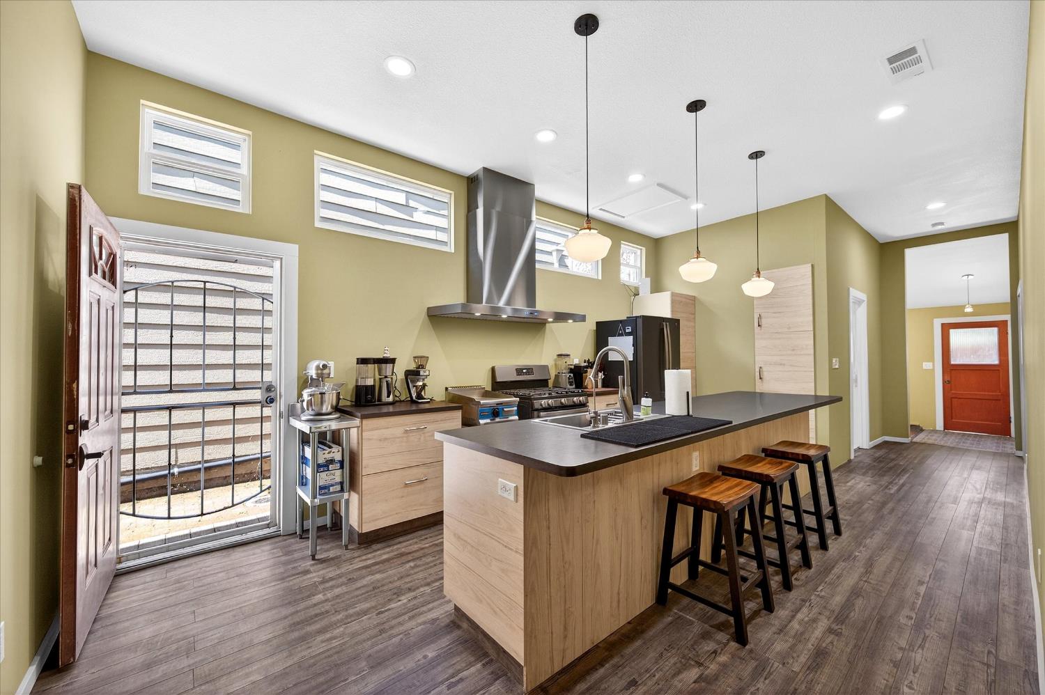 43 Main Street Isleton, CA 95641 - Photo 4 of 25 a kitchen with stainless steel appliances granite countertop wooden floors stove and sink