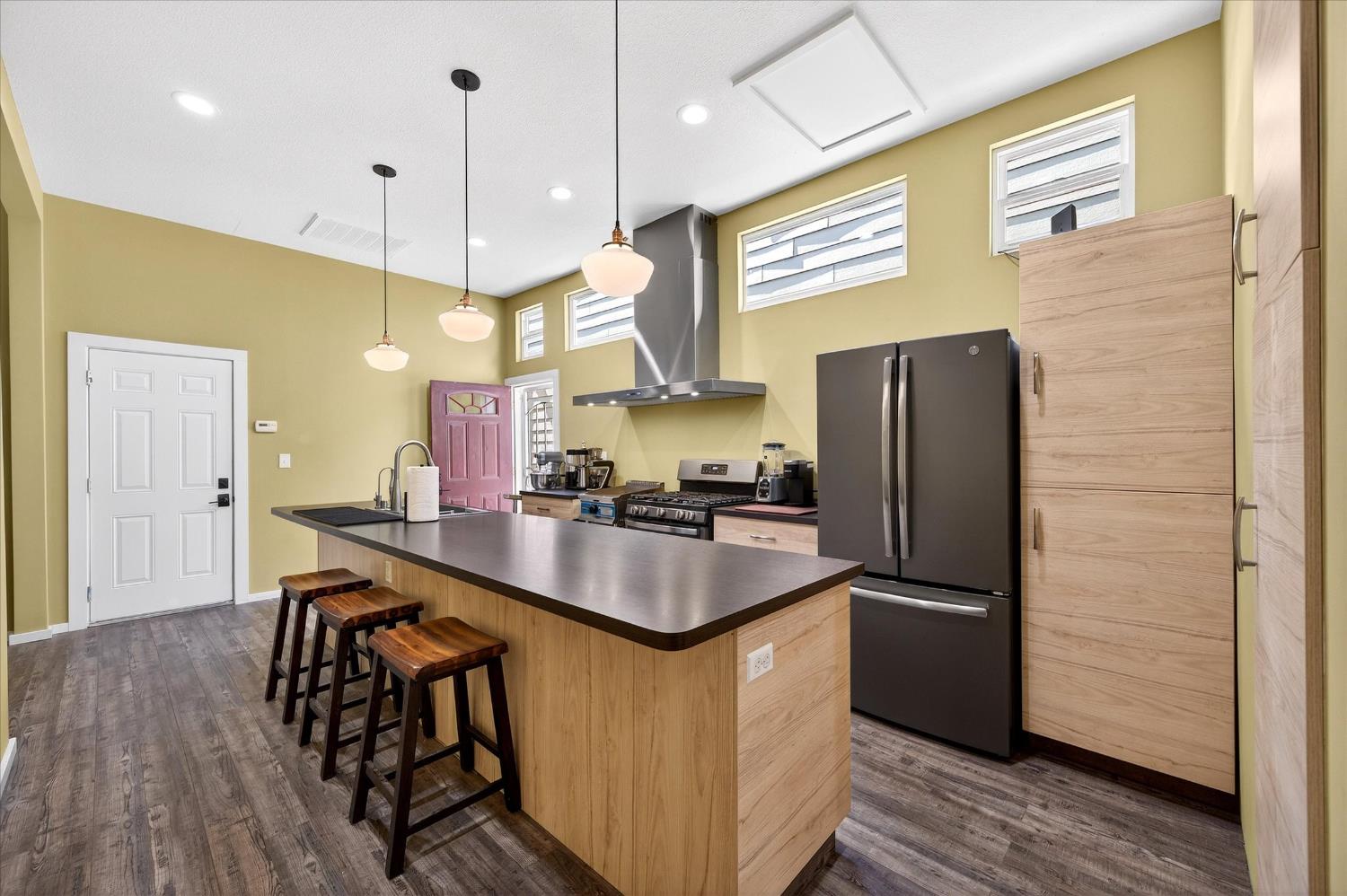 43 Main Street Isleton, CA 95641 - Photo 5 of 25 a kitchen with stainless steel appliances granite countertop a refrigerator a sink dishwasher a refrigerator and wooden floor