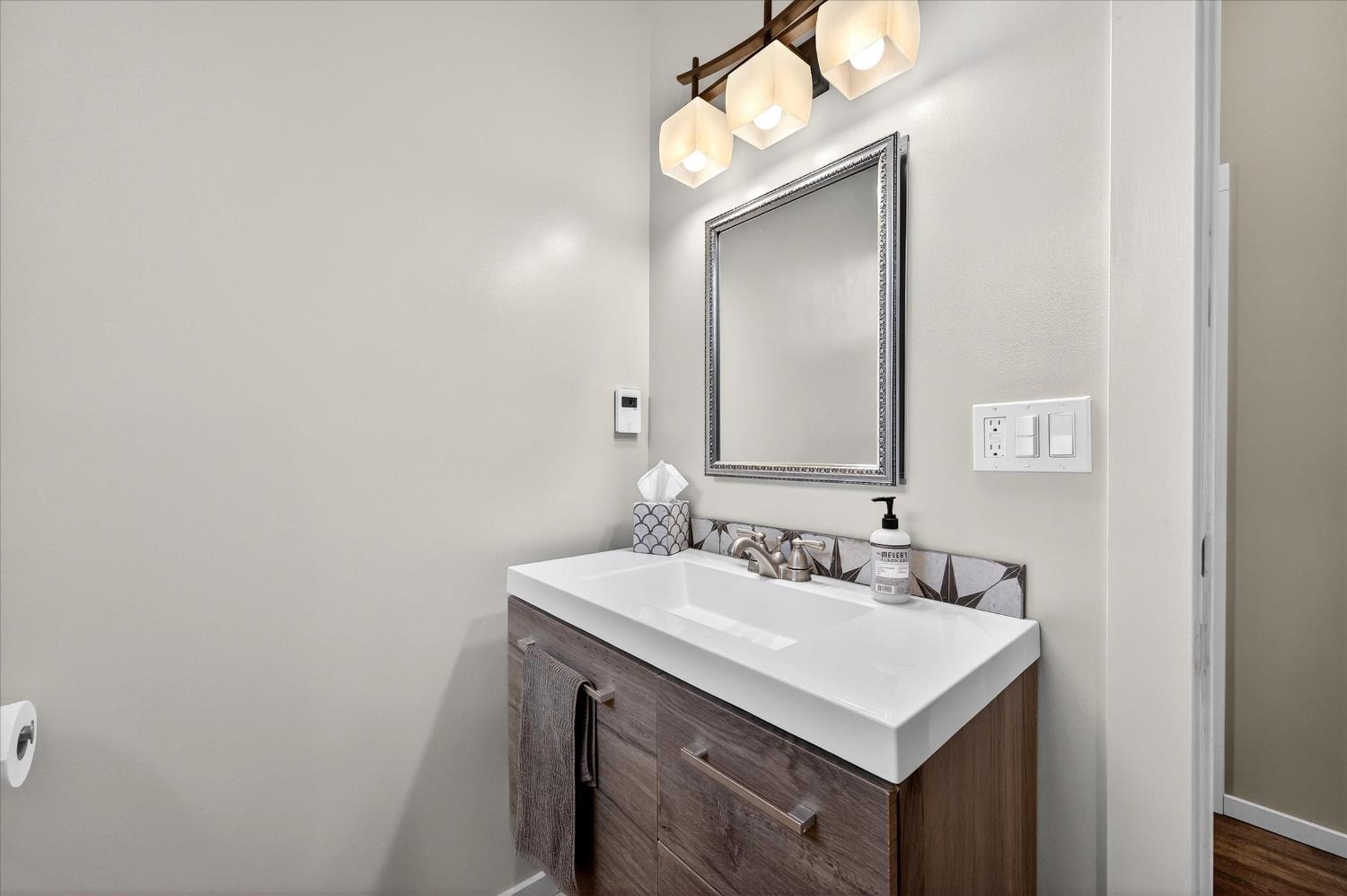 43 Main Street Isleton, CA 95641 - Photo 10 of 25 a bathroom with a sink and a mirror