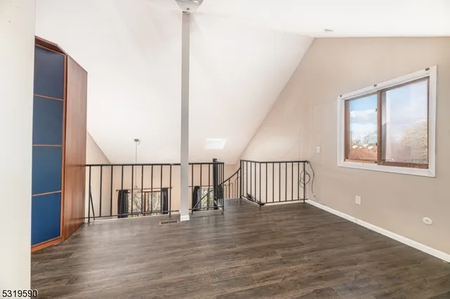a view of staircase with wooden floor and fan