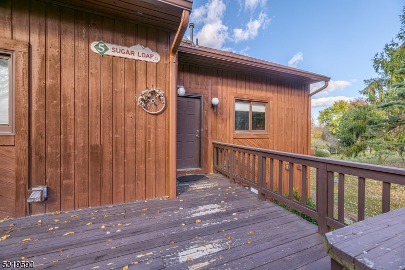 5 Sugar Loaf Court, Unit 7 Vernon, NJ 07462 - Photo 2 of 20 a view of porch with wooden floor