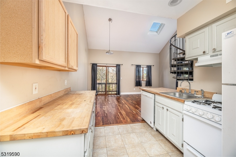 5 Sugar Loaf Court, Unit 7 Vernon, NJ 07462 - Photo 3 of 20 a large kitchen with kitchen island a sink stove and cabinets