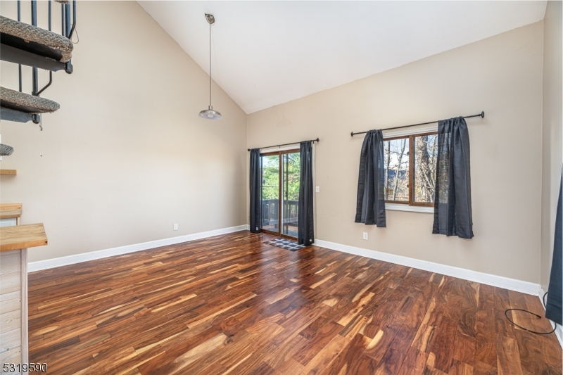 5 Sugar Loaf Court, Unit 7 Vernon, NJ 07462 - Photo 10 of 20 a view of an empty room with wooden floor and a window